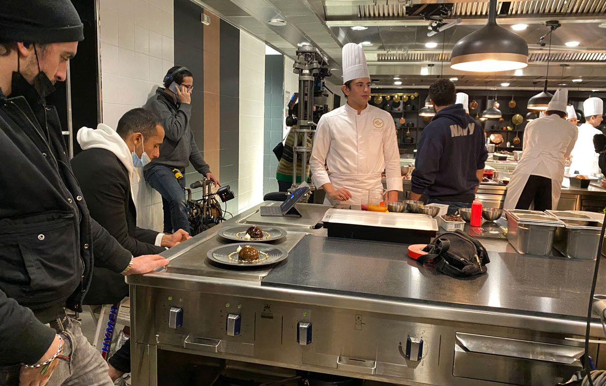 A La Belle Etoile : seated at left: Yazid Ichemrahen (world pastry champion) and standing in chef garb, Riadh Belaïche, who plays him in the movie
